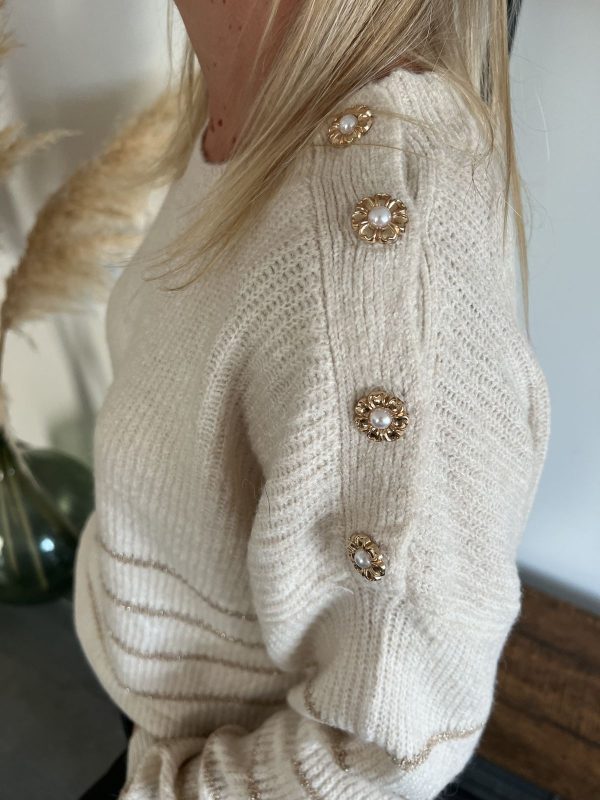 pull beige avec boutons en forme de fleur